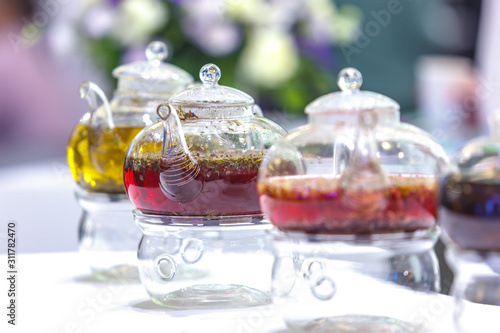 Transparent glass teapots with brewed tea