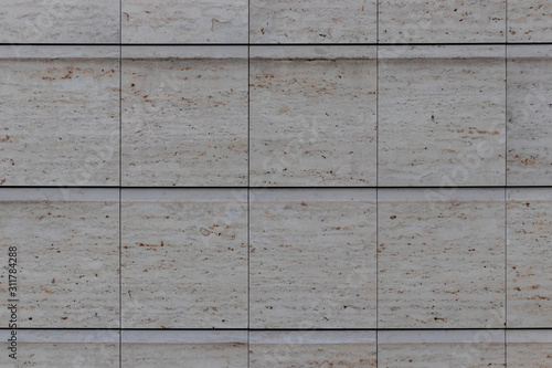 A wall with white big stones in a nice square pattern