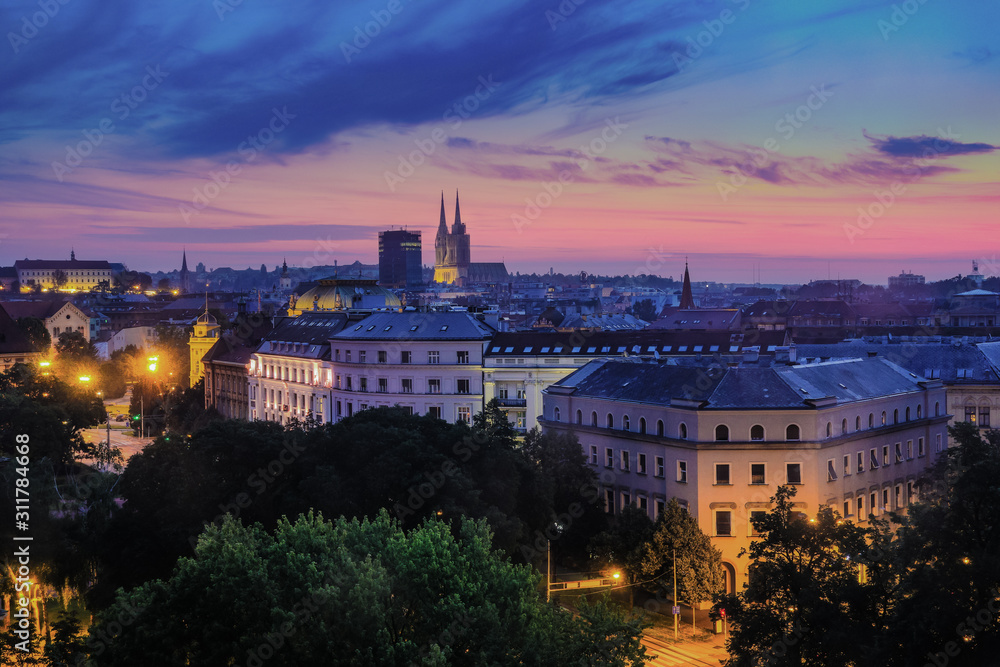 Zagreb, Croatia, Europe. Aerial view on rooftops and Cathedral tower in colorful sunrise, moments before dawn