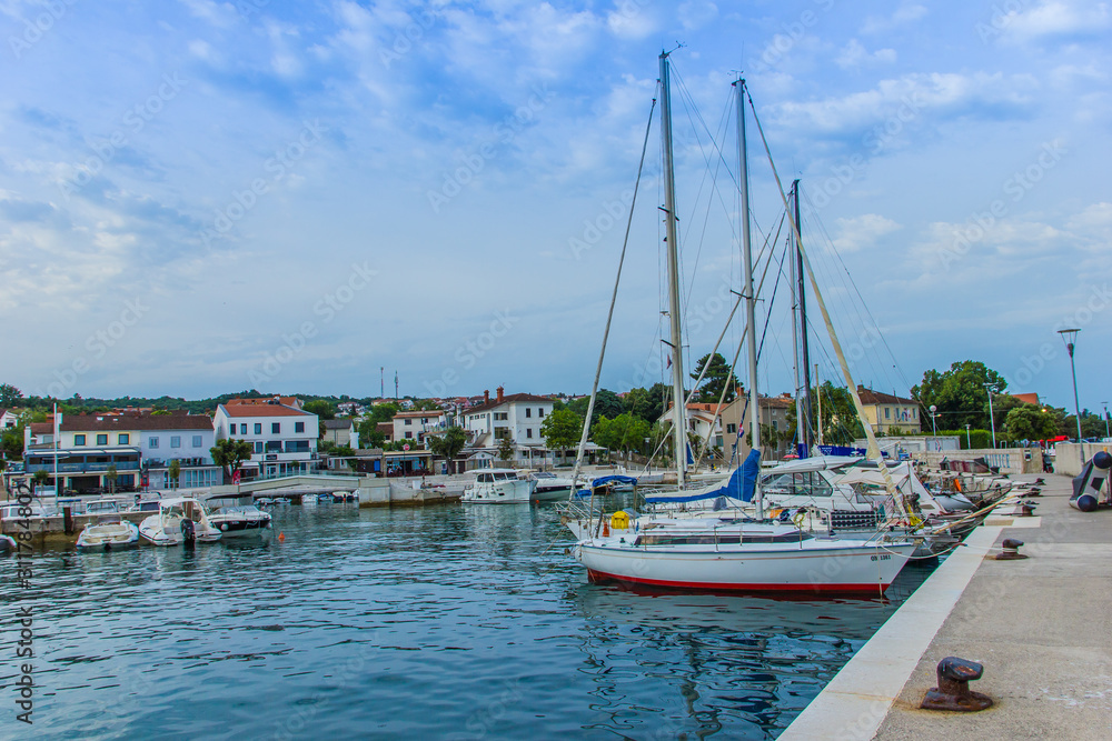 Njivice, Croatia / 22nd June 2019: Boats in harbour in colorful town Njivice, Krk island, Croatia