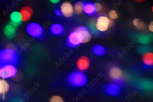Abstract background of blurred Christmas lights in the dark