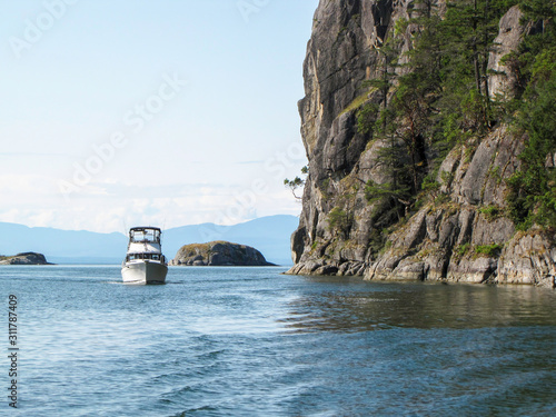 Boat beside cliff