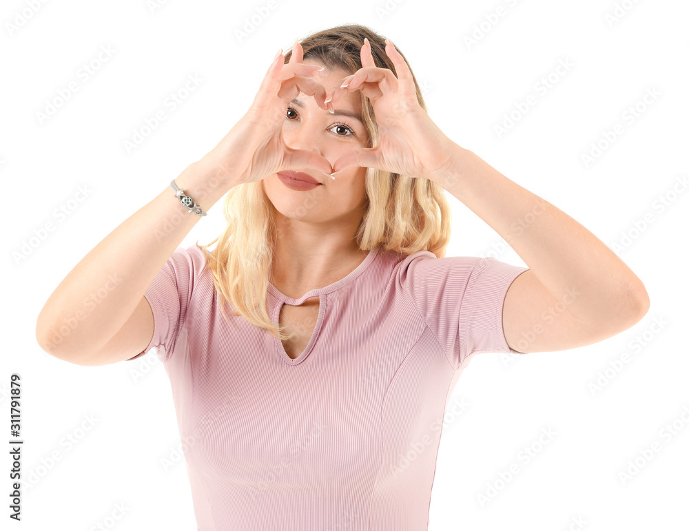 Beautiful young woman making heart with her hands on white background Beautiful young woman making heart with her hands on white background
