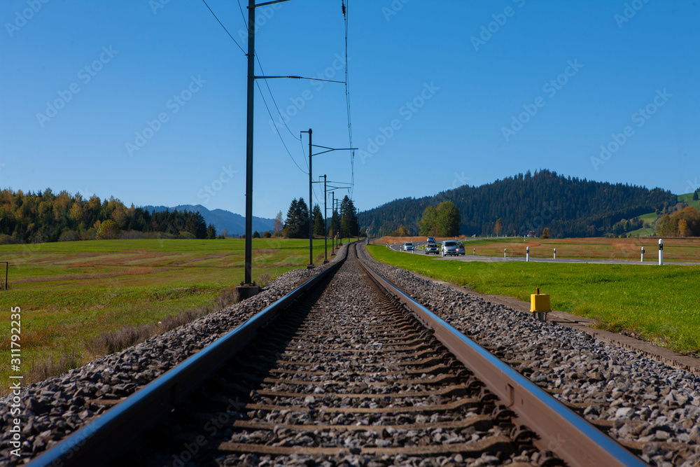 Railroad track in Switzerland converging in horizon