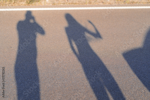 Shadows and silhouettes of people at a city during sunset. Shadows of the family while thay was running together in the evening. photo