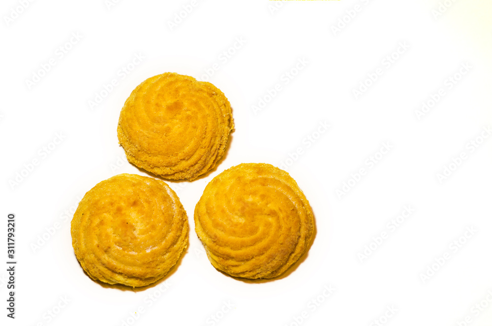 Three delicious round cookies lie on a white background in the shape of a triangle. Selective focus. Three delicious round cookies lie on a white background in the shape of a triangle. Selective focus.