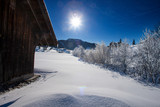 sun and blue sky on a cold day in the swiss mountains with snow landscape
