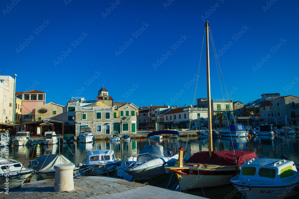 Vodice, Croatia / 17th May 2019: Boats in marina Vodice and old stone houses in city centre