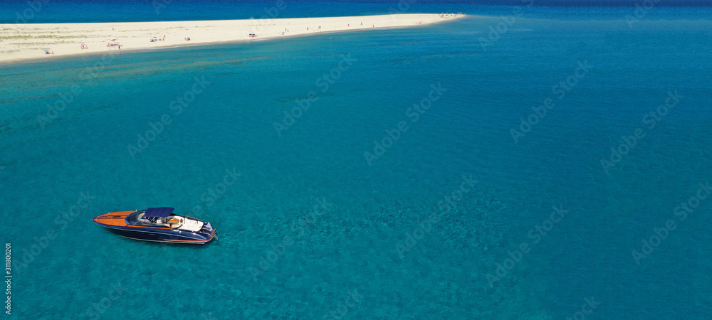Naklejka premium Aerial drone ultra wide photo of luxury yacht docked in tropical exotic turquoise beach