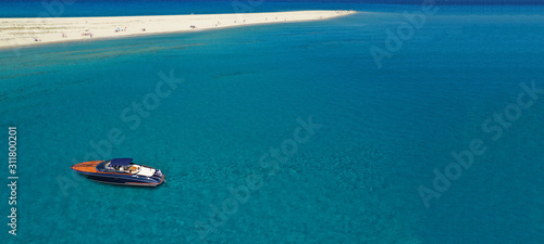 Aerial drone ultra wide photo of luxury yacht docked in tropical exotic turquoise beach © aerial-drone