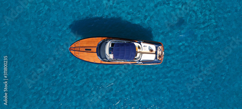 Aerial drone ultra wide photo of luxury yacht docked in tropical exotic turquoise beach