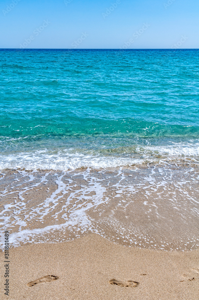 Blue sea on Aegean sea. Sandy beach in Greece
