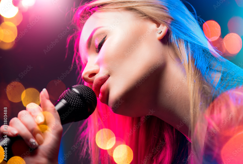 Beautiful Singing Girl. Beauty Glamour fashion Woman with Microphone over  Blinking bokeh night background. Glamour Model Singer. Karaoke song, party.  Rock star singer on music concert Stock Photo | Adobe Stock