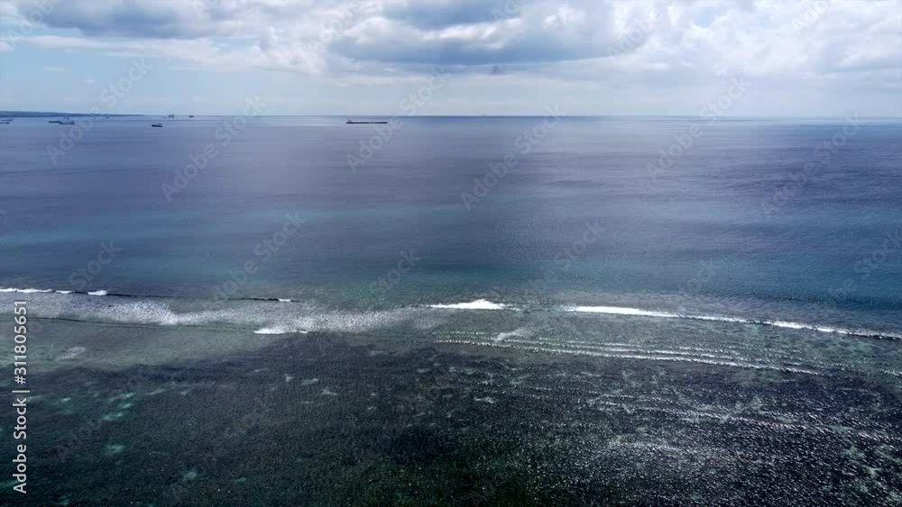 Aerial : Flight Over The Ocean And giant container ship in background