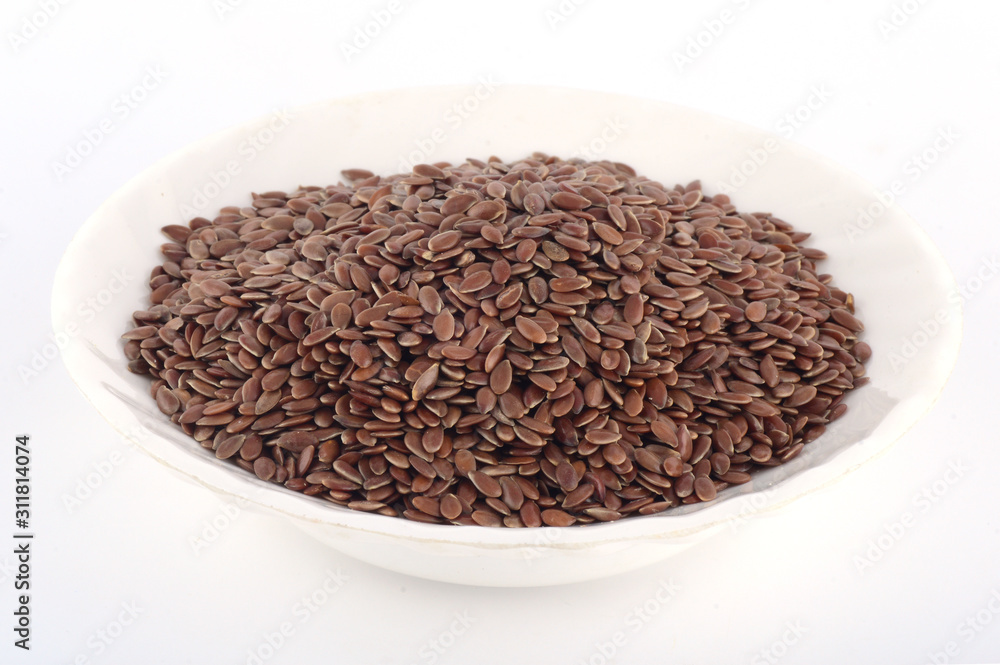 close up of flax seeds in white plate isolated on white background close up of flax seeds in white plate isolated on white background