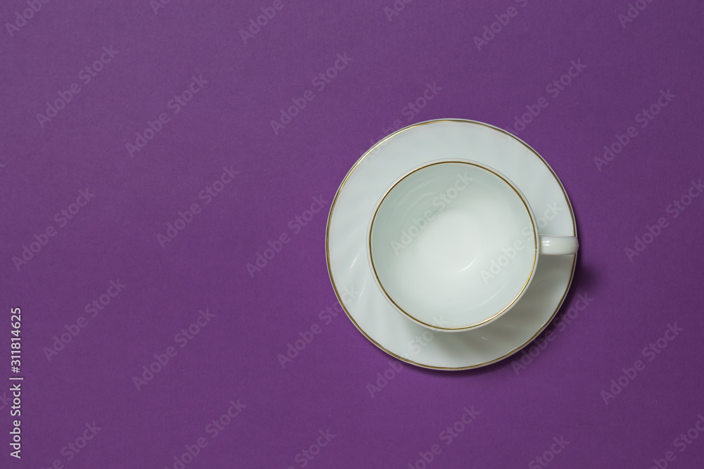 White ceramic coffee Cup on a lilac background. Flat lay. White ceramic coffee Cup on a lilac background. Flat lay.