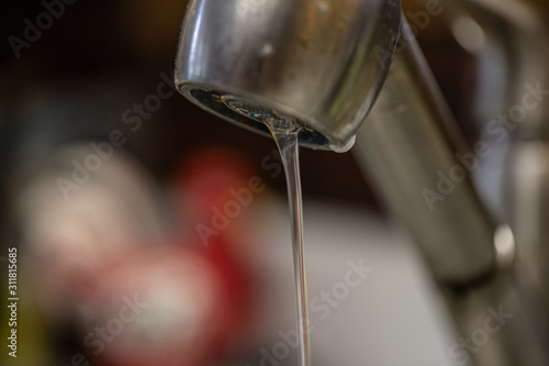 Canvas Print Water running slowly from faucet