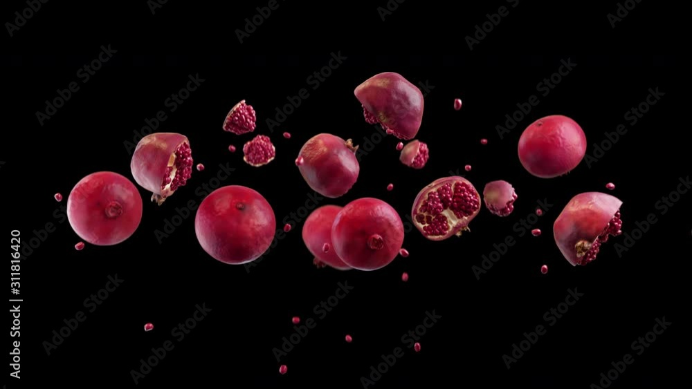 Pomegranate tossed up in slow motion, hanging in air and falling down on black background. Healthy Diet Superfood thrown from below. Pomegranate tossed up in slow motion, hanging in air and falling down on black background. Healthy Diet Superfood thrown from below.