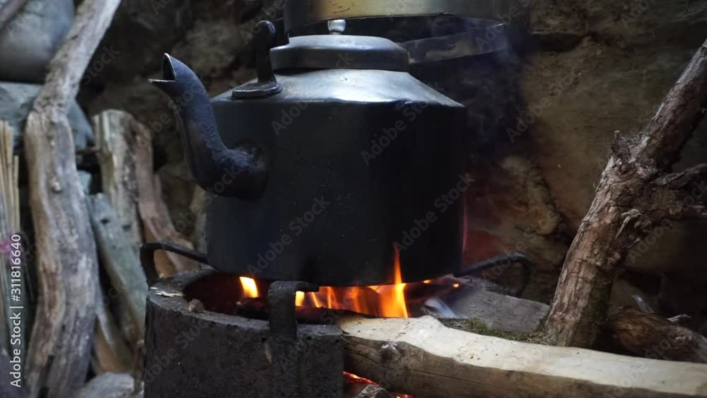 Video of boiling water with firewood in a black kettle Video of boiling water with firewood in a black kettle