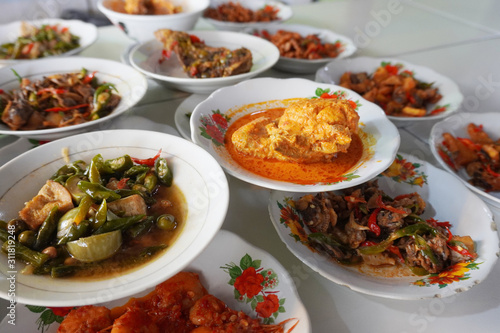 Nasi Padang is a Padang steamed rice served with various choices of pre-cooked dishes like seafood, vegetable and fermented tofu originated from Indonesia. 
