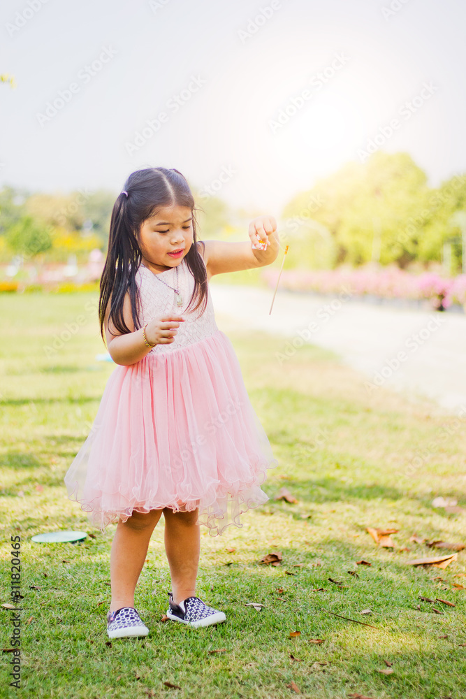  A little girl that is swimming in the grass