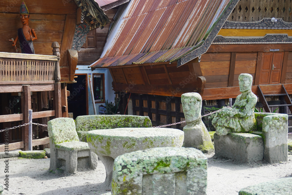 Stone chairs of Ambarita and traditional Batak roof houses, Samosir Island, Lake Toba Stone chairs of Ambarita and traditional Batak roof houses, Samosir Island, Lake Toba