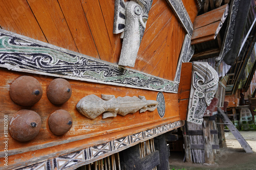 Batak carving on the wall of the village in the area of the Toba lake. Samosir Island, Indonesia photo