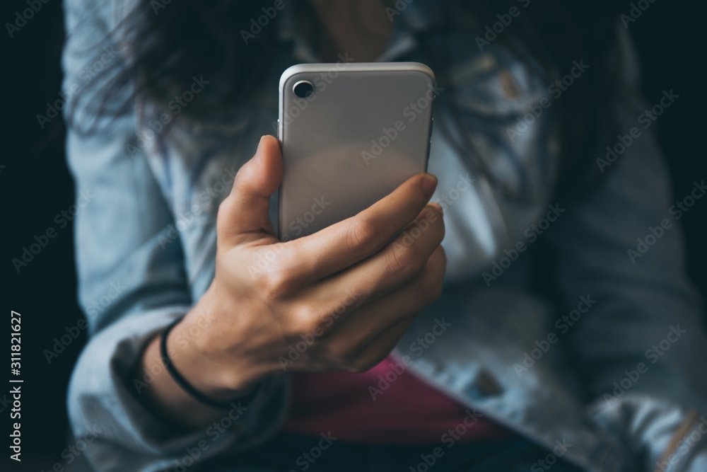 using cell phone.hand holding texting message on screen mobile chatting friend ,search internet information sitting on sofa in office.technology device contact communication connecting people concept using cell phone.hand holding texting message on screen mobile chatting friend ,search internet information sitting on sofa in office.technology device contact communication connecting people concept