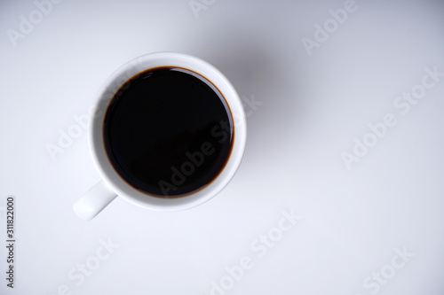 Cup of coffee on white with space from top view