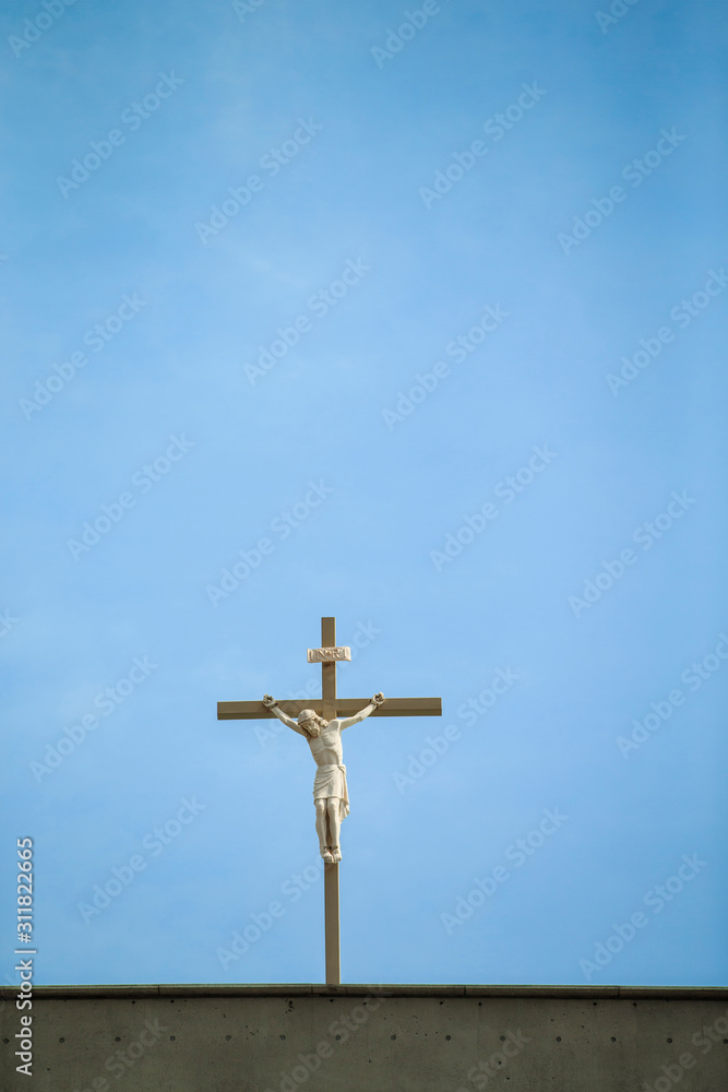 Catholic Church's Statue of jesus on cross against blue sky, top of the world. Catholic Church's Statue of jesus on cross against blue sky, top of the world.