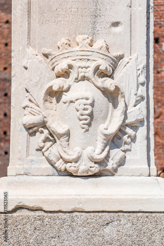 Statue on the brick wall of Sforza Castle (Castello Sforzesco), built in the 15th century by Francesco Sforza, Duke of Milan, on the remnants of a 14th-century fortification.