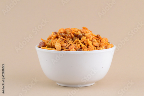 Indian Snacks : Mixture (roasted nuts with salt pepper masala, pulses, channa masala dal green peas) in blue bowl in photo