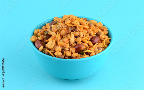 Indian Snacks : Mixture (roasted nuts with salt pepper masala, pulses, channa masala dal green peas) in blue bowl in photo