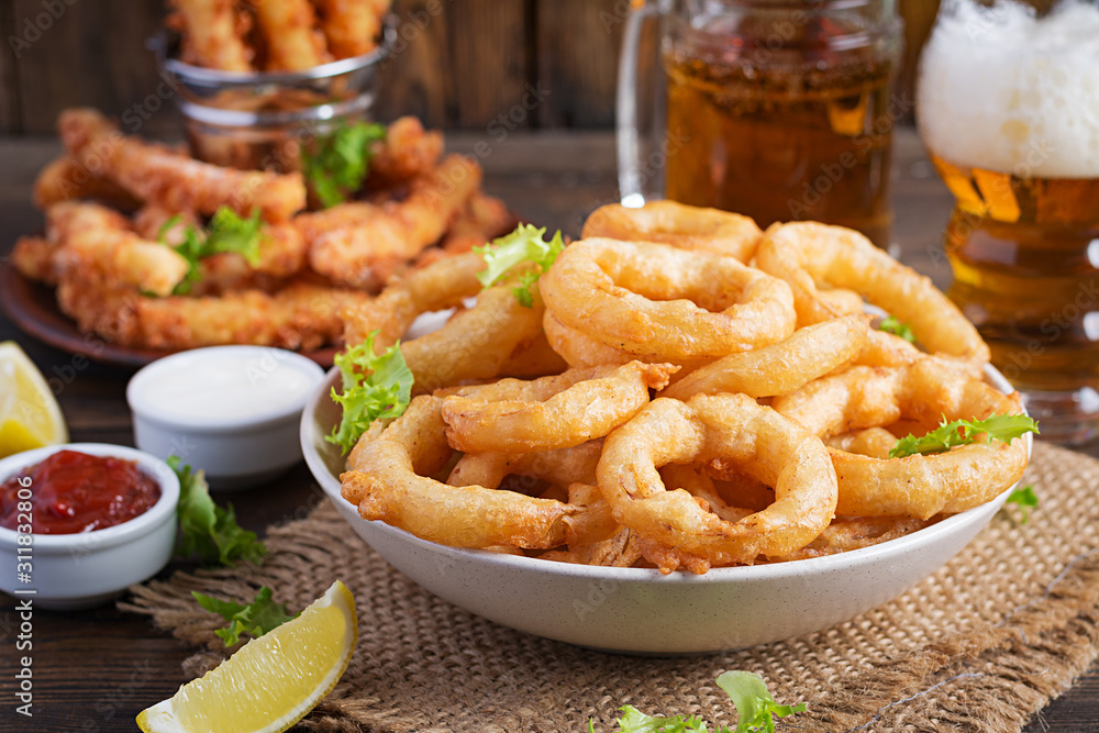 Onion rings in batter with sauce and cheese sticks. Beer snacks. Copy space Onion rings in batter with sauce and cheese sticks. Beer snacks. Copy space