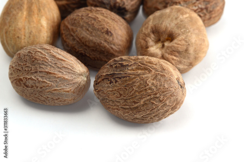 Nutmeg isolated on white background. Close up. photo