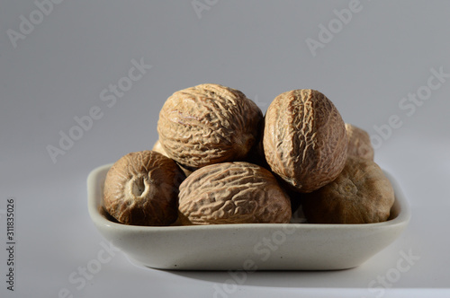 Close up of Nutmeg in a white plate photo