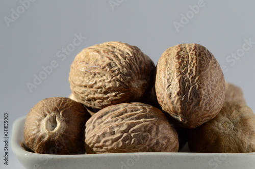 Close up of Nutmeg in a white plate photo