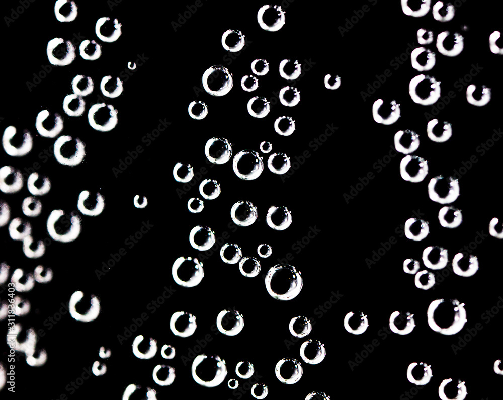 Air balls in water on a black background