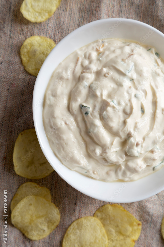 Top view, Homemade Caramelized Onion Dip with Potato Chips on cloth. Flat lay, overhead, from above. Close-up. Top view, Homemade Caramelized Onion Dip with Potato Chips on cloth. Flat lay, overhead, from above. Close-up.