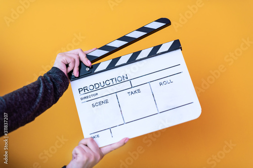 Fényképezés movie clapper isolated on yellow background