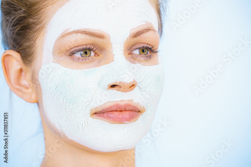 Girl with dry white mud mask on face