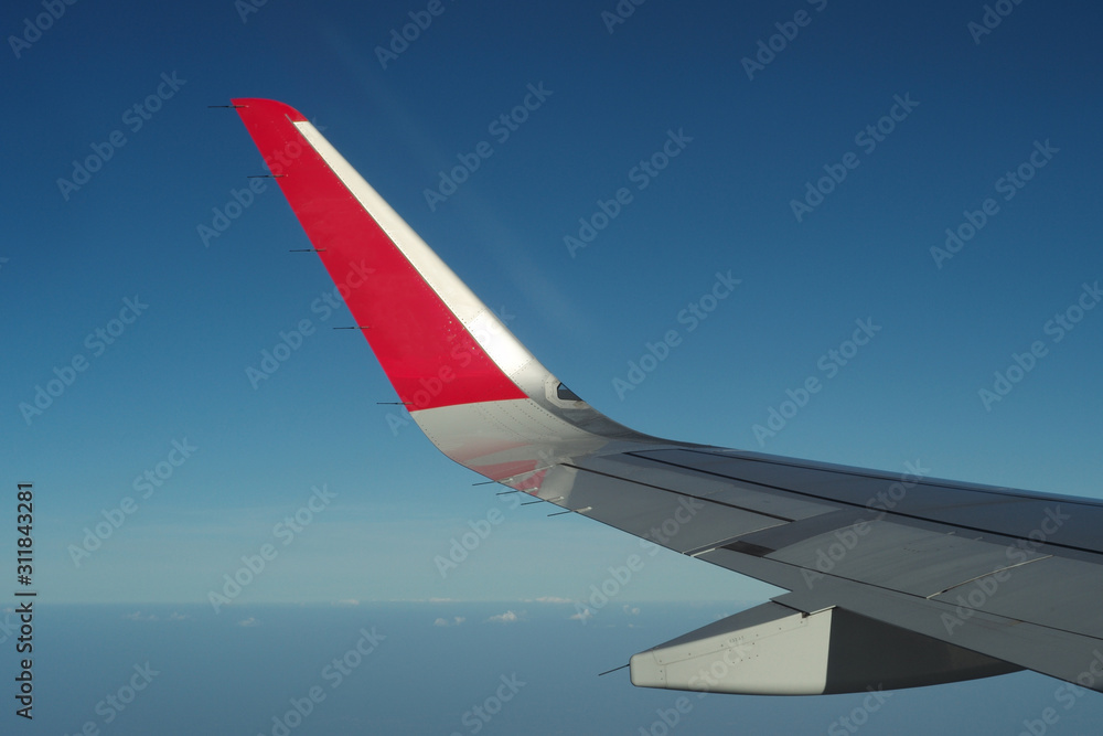 Fototapeta premium Top view crowd of cityscape looking down from airplane while flying in the sky