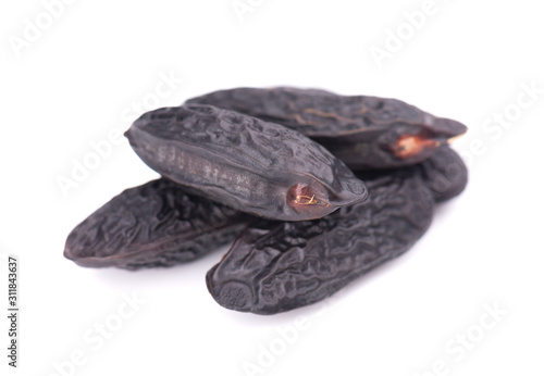 Tonka beans isolated on white background. Bean of Dipteryx odorata, cumaru or kumaru. Fresh aroma tonka beans. photo