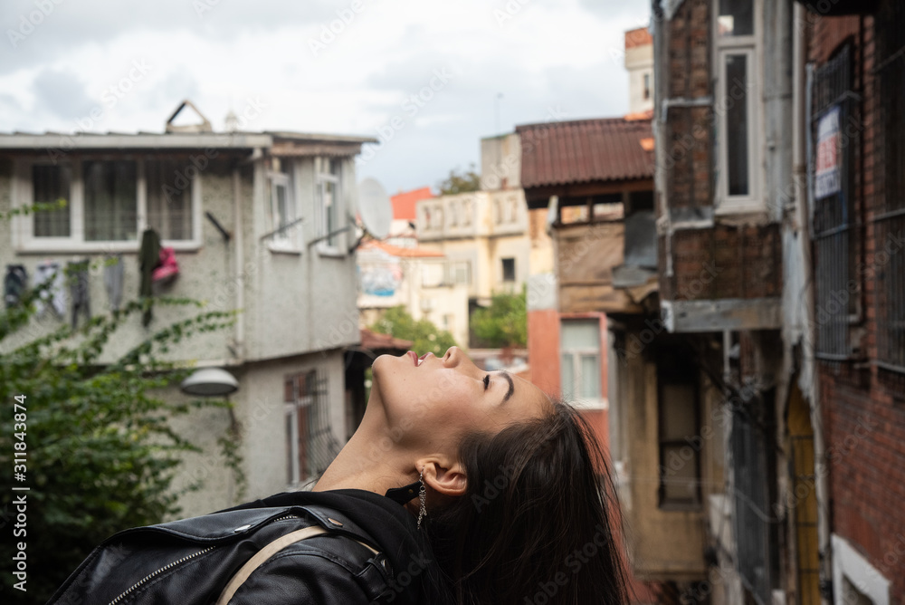 Asian girl looking up in profile in old Istanbul's district Fener/Balat