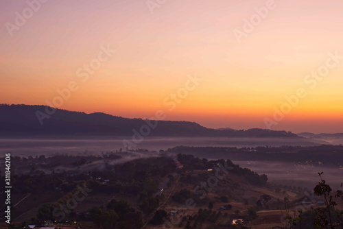 Sunrise and morning light behind the mountains with the mist covered at Khao Takhian Ngo Phetchabun in Thailand © Nueng