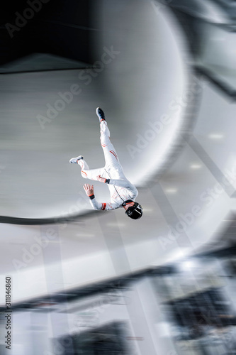 Speed. Fly men is a pilot of his body in air. Extreme people prefer skydiving. Parachutist in white suit. Free lifestyle.