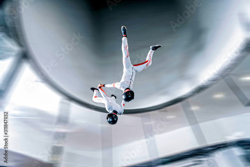 Speed. Fly men is a pilot of his body in air. Extreme people prefer skydiving. Parachutist in white suit. Free lifestyle.