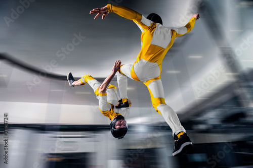 Speed. Fly men is a pilot of his body in air. Extreme people prefer skydiving. Parachutist in yellow suit. Free lifestyle.