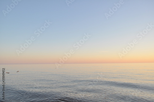 Photo of a beautiful sunset. The beach, an endless beautiful pond. Horizontal image. Pastel colors and shades. © Елена Костина