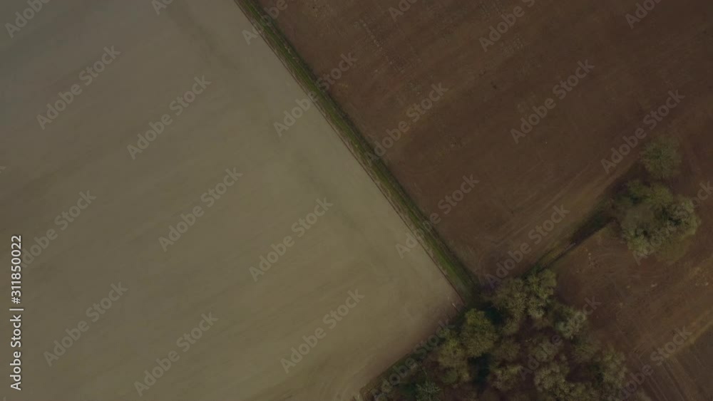 Aerial drone shot during winter over farm land showing different earths, colours and textures. Aerial drone shot during winter over farm land showing different earths, colours and textures.